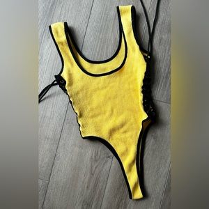 Yellow and black lace up thong bodysuit